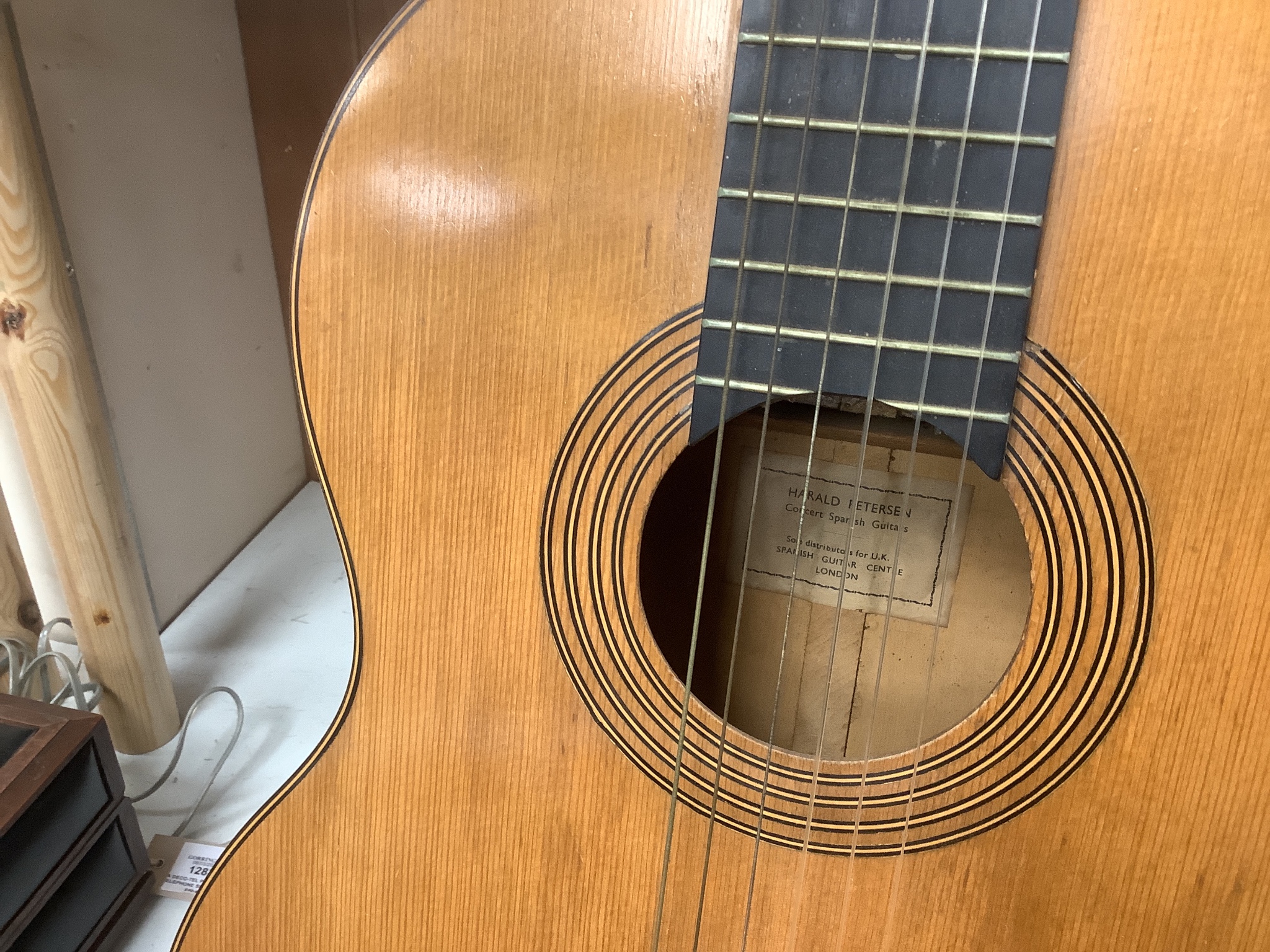 A Harald Petersen classical concert guitar, paper label interior, with hard case. Length of back 49cm excluding button